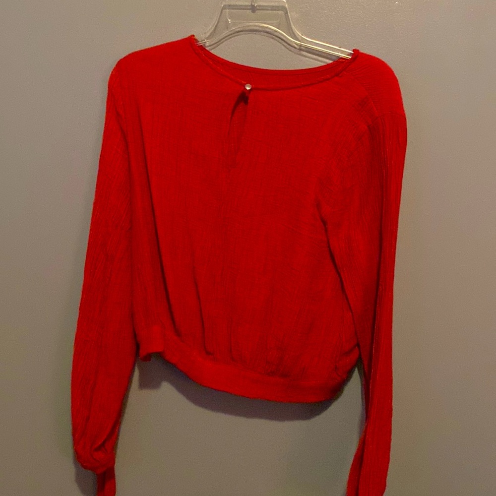 Reddish Orange long sleeved shirt. No damage. Size medium.